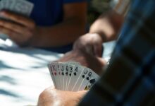 Players holding sets of cards in their hands