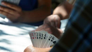 Players holding sets of cards in their hands